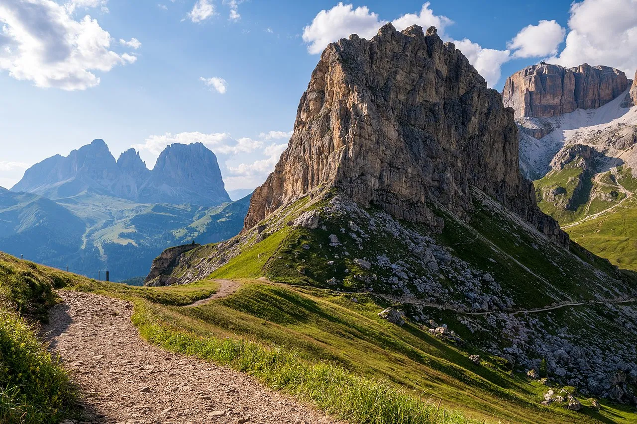 Dolomite towers above the green ridges around Passo Pordoi